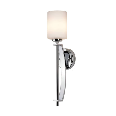 The Taylor 1 Light Large Wall Light - Polished Chrome showcases a sleek polished chrome finish and a cylindrical opal etched glass shade. Its minimalist design includes a long vertical support attached to a round wall mount, gently diffusing light through the finely crafted glass.