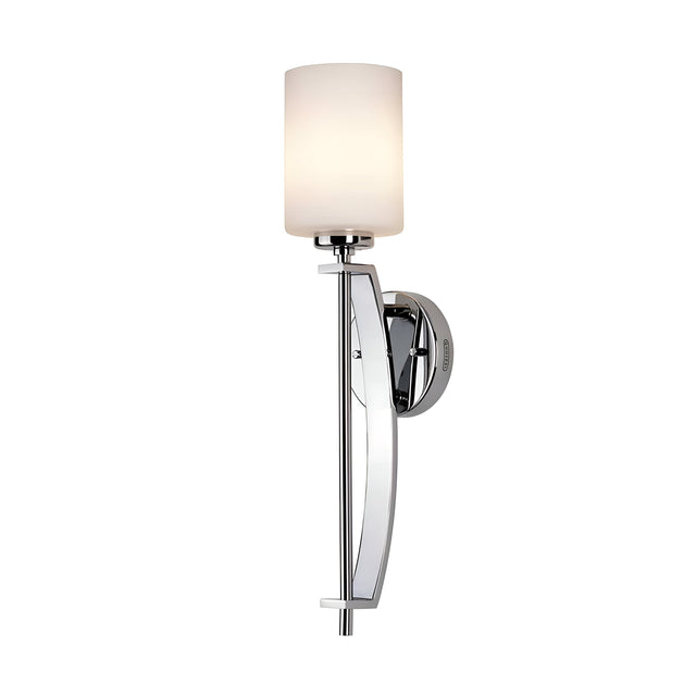 The Taylor 1 Light Large Wall Light - Polished Chrome showcases a sleek polished chrome finish and a cylindrical opal etched glass shade. Its minimalist design includes a long vertical support attached to a round wall mount, gently diffusing light through the finely crafted glass.