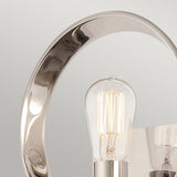 Close-up of the Theatre Row 1 Light Wall Light - Imperial Silver, showcasing an Edison-style bulb. The fixture features a sleek, circular metal frame in a reflective Imperial Silver finish against a neutral backdrop.