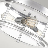 Close-up of the Trilogy 3 Light Flush featuring a sleek, circular metal frame with two exposed Edison-style bulbs. The polished chrome finish is smooth and reflective, enhancing its contemporary look against a neutral background.