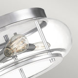 Close-up of the Trilogy 3 Light Flush in polished chrome, featuring a clear glass cover that reveals a visible bulb. The sleek flush mount design is elegantly displayed against a white ceiling.