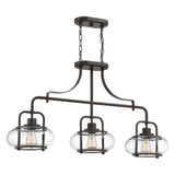 The Trilogy 3 Light Island Light in Olde Bronze features a modern industrial design with three round clear glass lampshades. Enhanced by LED filament bulbs, its curved metal arms provide an elegant and contemporary appearance.