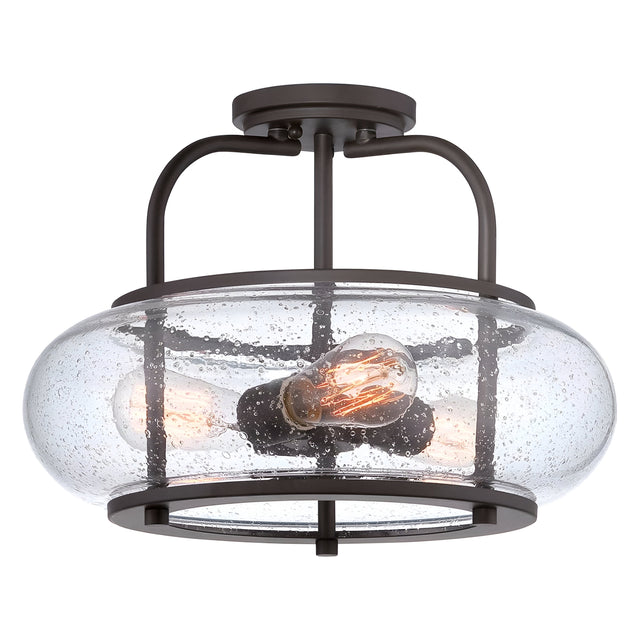 The Trilogy 3 Light Medium Semi-Flush in Old Bronze features a circular, seeded glass shade with a subtle bubbled texture. It houses three exposed filament bulbs within an old bronze metal frame, embodying the essence of industrial lighting.