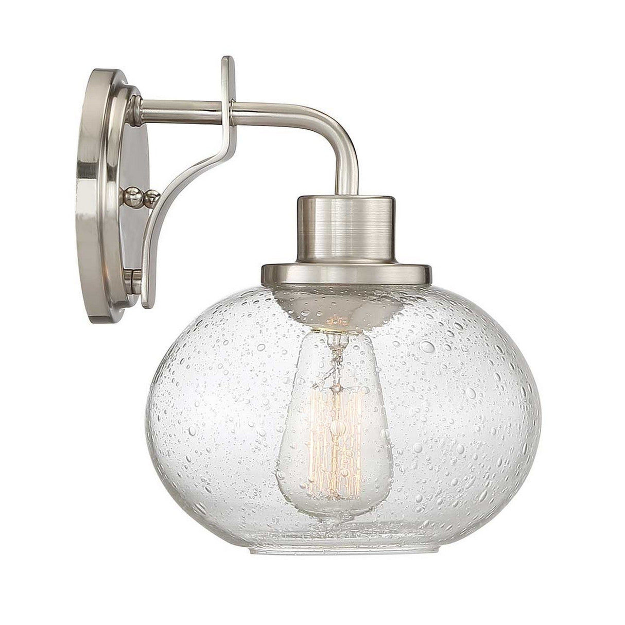 The Trilogy 1 Light Wall Light in brushed nickel features a clear, seeded glass globe with a textured, bubble-like pattern that encases an exposed vintage-style bulb, offering a modern and elegant design.