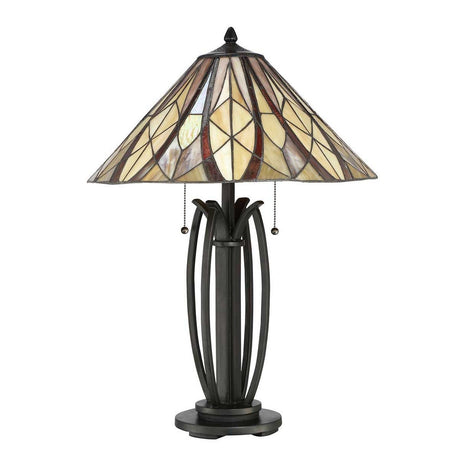 The Victory 2 Light Tiffany Table Lamp in Valiant Bronze boasts a stained glass shade adorned with geometric patterns in beige, brown, and yellow. Its base is dark, ornate, and features elegant metal curves along with two pull chains for easy operation.