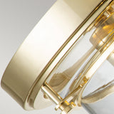 Close-up of the Whistling 3 Light Flush in polished brass, featuring a circular design with a glass cover. This IP44-rated fixture reflects light beautifully off its shiny metal surface, making it ideal for bathroom lighting to highlight its sleek and modern design.