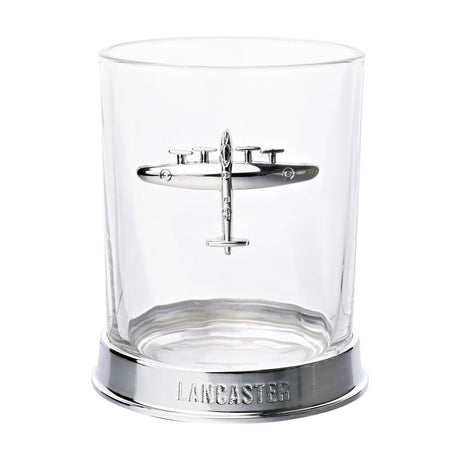 Clear glass whiskey tumbler with a polished silver Lancaster bomber emblem on the front, set on a metal base lettered "LANCASTER", shown on a white background.