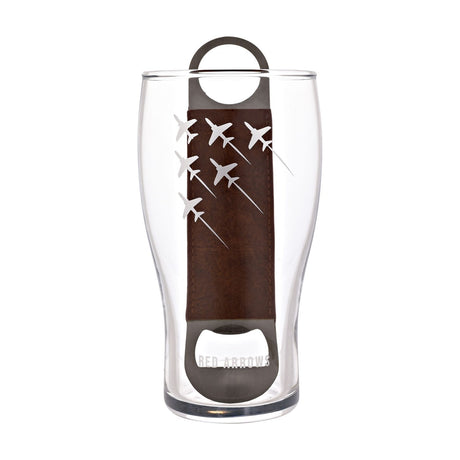 Clear tulip-shaped pint beer glass etched with six jets in diagonal formation and "RED ARROWS" text, paired with a brown leather-wrapped metal bottle opener, on a white background.