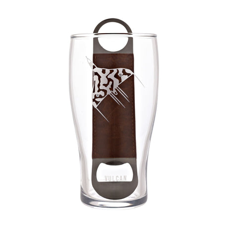 Clear pint glass etched with a frosted Vulcan aircraft design and "VULCAN" text, paired with a stainless steel bottle opener and brown strap handle, on a plain white background.