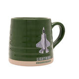 Green ribbed stoneware mug with an F-35B Lightning jet graphic and "LIGHTNING" text, beige base band, green handle, on a plain white background.