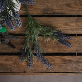 Hill Interiors Small Lavender Spray with purple florets and grey-green foliage laid on a rustic wooden pallet beside metal snips and further lavender stems.