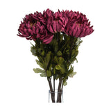 Hill Interiors Autumn Spider Chrysanthemum faux stems with purple shaggy blooms and green foliage arranged in a clear glass vase on a white background.
