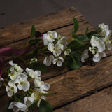 Hill Interiors White Spring Mock Orange faux flower stem with cupped white blooms and green leaves, tied with a burgundy ribbon on a rustic wooden crate.