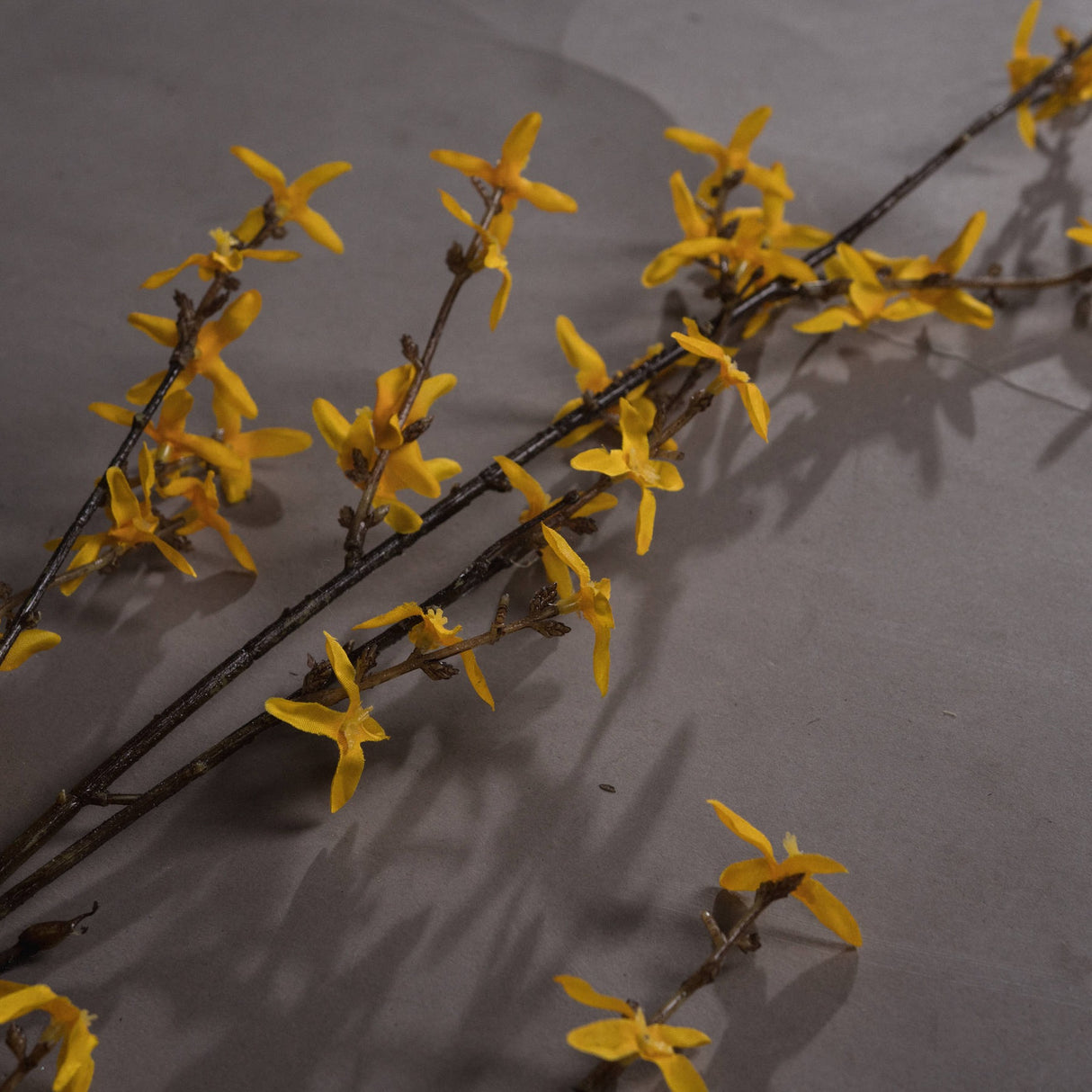 Hill Interiors Forsythia faux flower stem with clusters of small four-petalled yellow blooms along slender woody branches, shown on a neutral background.