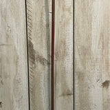 Close-up of weathered whitewashed wooden planks with visible grain, knots, and a narrow reddish-brown vertical strip behind Hill Interiors Pink Allium.