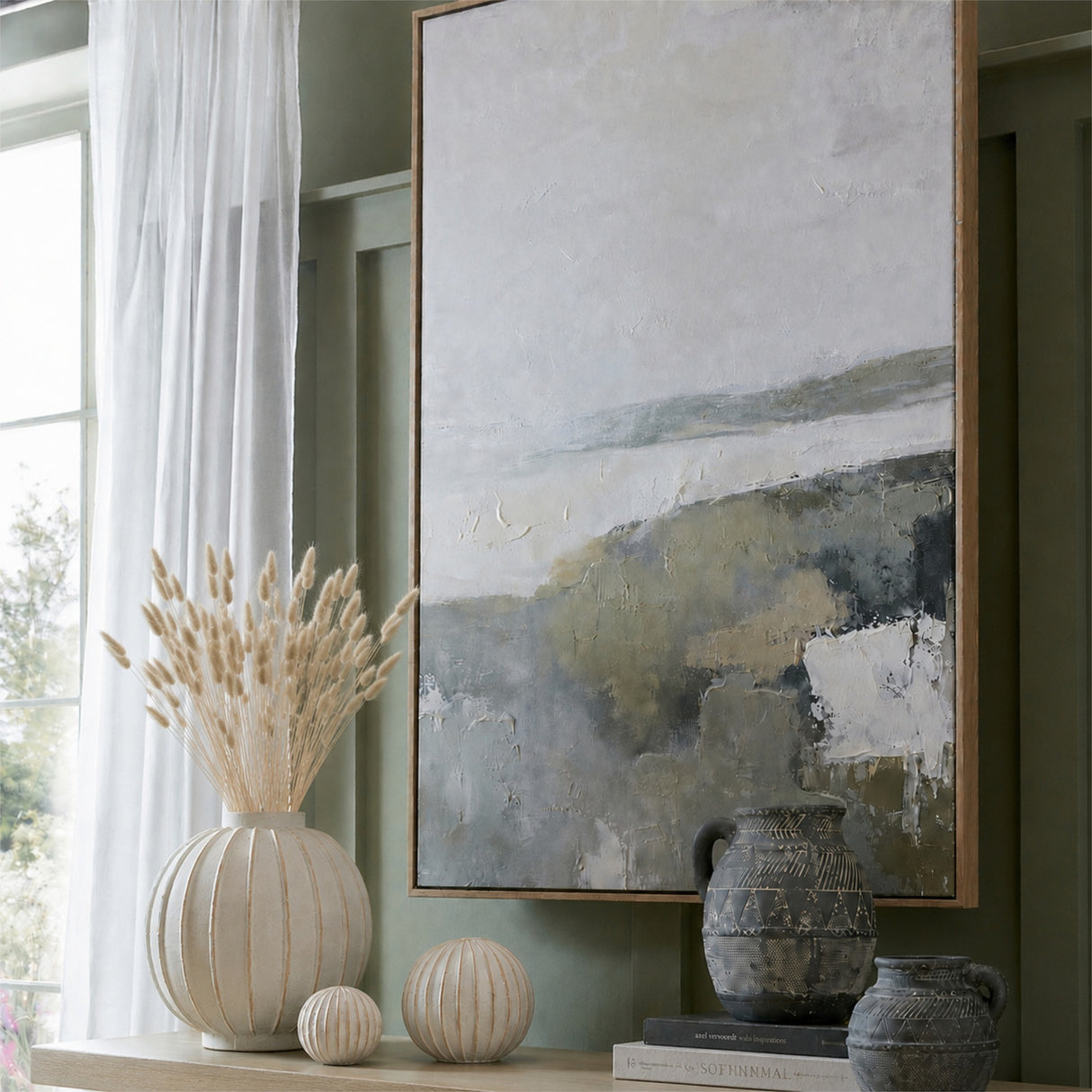 Hill Interiors Dried Natural Bunny Tail Bunch of 40 arranged in a white ribbed vase on a sideboard beside ceramic spheres and dark patterned jugs.