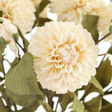 Close-up of the Hill Interiors White Dahlia Stem faux flower, showing layered cream-white petals forming a rounded bloom with green leaves along the stem.