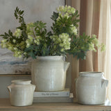 Hill Interiors Long Fennel Stems with feathery green and cream plumes arranged in a rustic stone pot, styled with books beside two smaller ceramic jars.