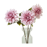 Three Hill Interiors Pink Dahlia faux stems with layered blush petals and green leaves arranged in a clear glass vase against a white background.