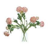 Hill Interiors Pink Ranunculus faux stems with layered blush blooms and green foliage arranged in a slim clear glass vase on a white background.