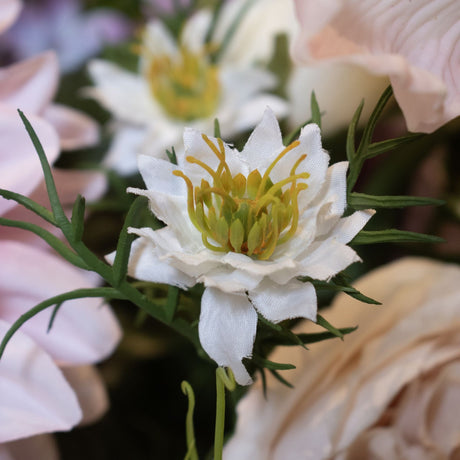 Close-up of Hill Interiors White Nigella Love In A Mist faux flower stem, showing white star-shaped petals, yellow-green stamens and feathery foliage.