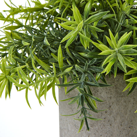 Close-up of Hill Interiors Small Bamboo Plant showing slim green plastic leaves fanning from upright canes above a textured grey pot.