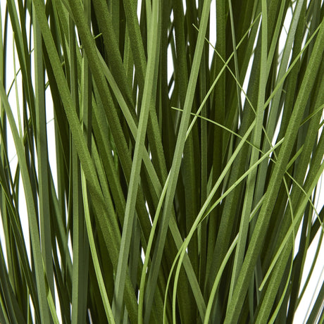 Close-up of the long, slender green strappy leaves of the Hill Interiors Blue Agapanthus faux potted plant.