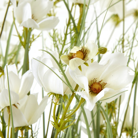 Close-up of Hill Interiors Large White Meadow Plant In Pot showing delicate white blooms with yellow centres on slim green stems against a light background.