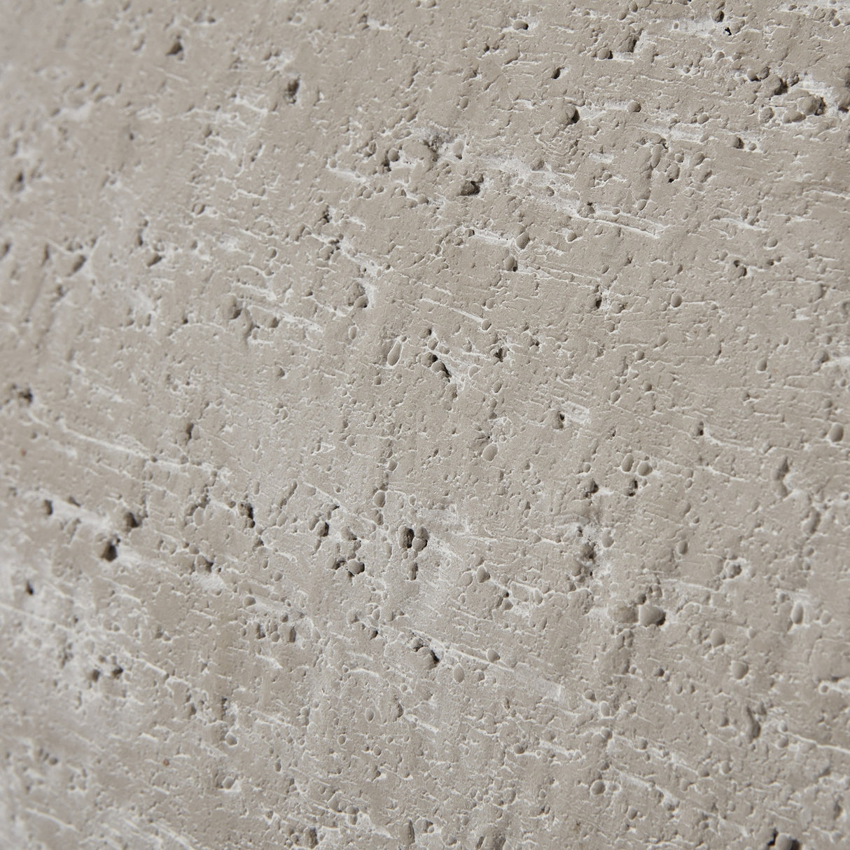 Close-up of the Hill Interiors Ordo Shaded Sand planter surface showing textured beige finish with pitted, stone-like detailing.