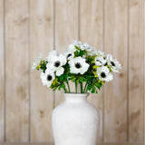 Hill Interiors White Anemone Spray artificial stems with dark centres arranged in a white ceramic vase against a light wood plank backdrop.