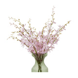 Hill Interiors Lilac Cymbidium Spray faux orchid stems with soft purple blooms and slender budded branches, arranged in a green glass vase.