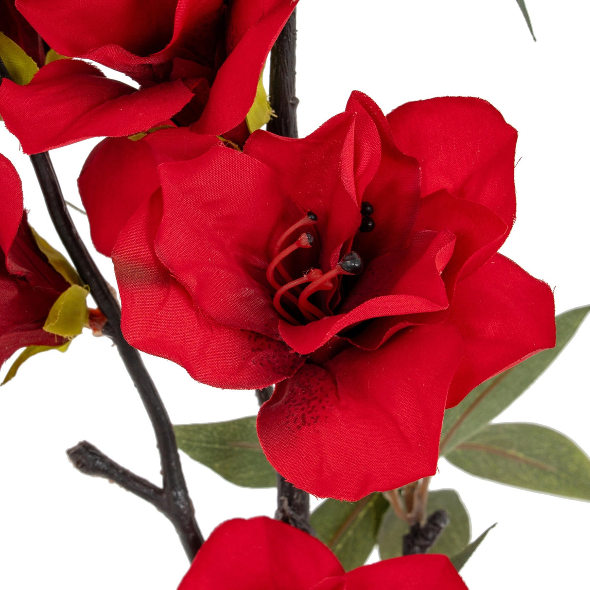 Close-up of the Hill Interiors Crimson Bloom Large Spray showing layered red faux flowers with visible stamens, buds and green foliage on a dark stem.