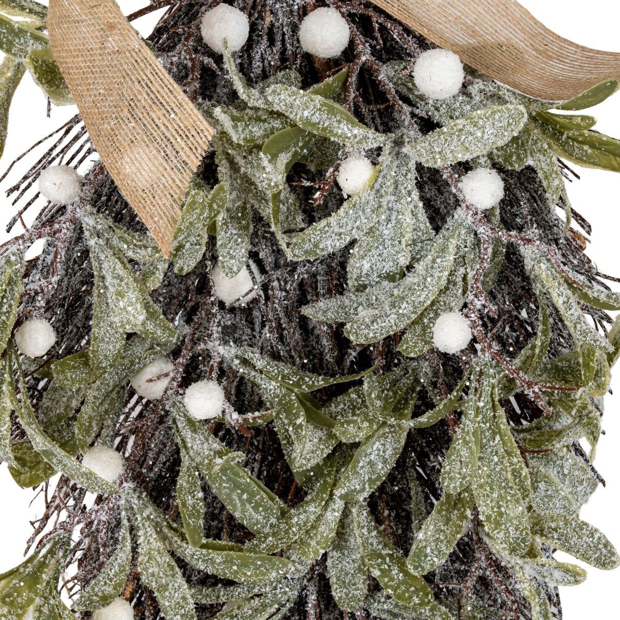 Close-up of Hill Interiors Frosted Mistletoe and Pine Swag with frosted leaves, white berries and pine twigs tied with natural burlap ribbon.