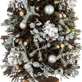 Close-up of Hill Interiors Large Frosted Forest Tree showing twig branches, frosted needles, snow-dusted pinecones and silver pearl baubles on a wood base.