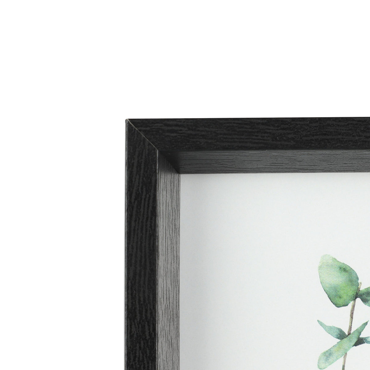 Close-up of the Renabie black photo frame's corner, showing its deep box profile, wood-textured finish, and glass front over a botanical print, against a white background.