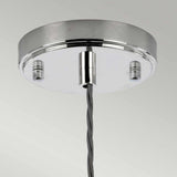 Close-up of the Reno 1 Light Pendant in polished nickel with a smoke glass shade and metal canopy. A twisted grey cord extends from the center, connecting to a lamp holder for the pendant light. The background is a plain, light grey.