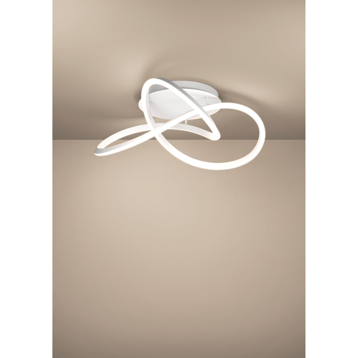 Riaza LED ceiling light in white, featuring a looped ribbon-style fixture crossing over itself beneath a round ceiling canopy, mounted close to a neutral-toned ceiling.