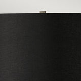 Close-up of the Ripple 1 Light Table Lamp featuring a black shade with a slightly textured surface. The top of this modern lamp showcases a small, metallic finial against a neutral background, blending seamlessly into your contemporary lighting setup.