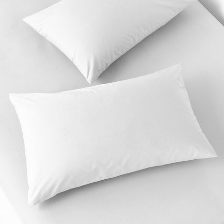 Two plain white 200 thread count percale cotton pillowcases with an envelope-style back opening, shown on a white bed against a light background.