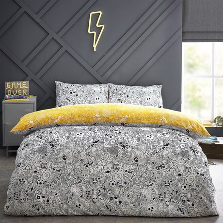 Doodles Polycotton Printed Duvet Cover Set in white/black with dense black doodle print, reversible to yellow, shown on a bed with matching pillowcases in a bedroom setting.