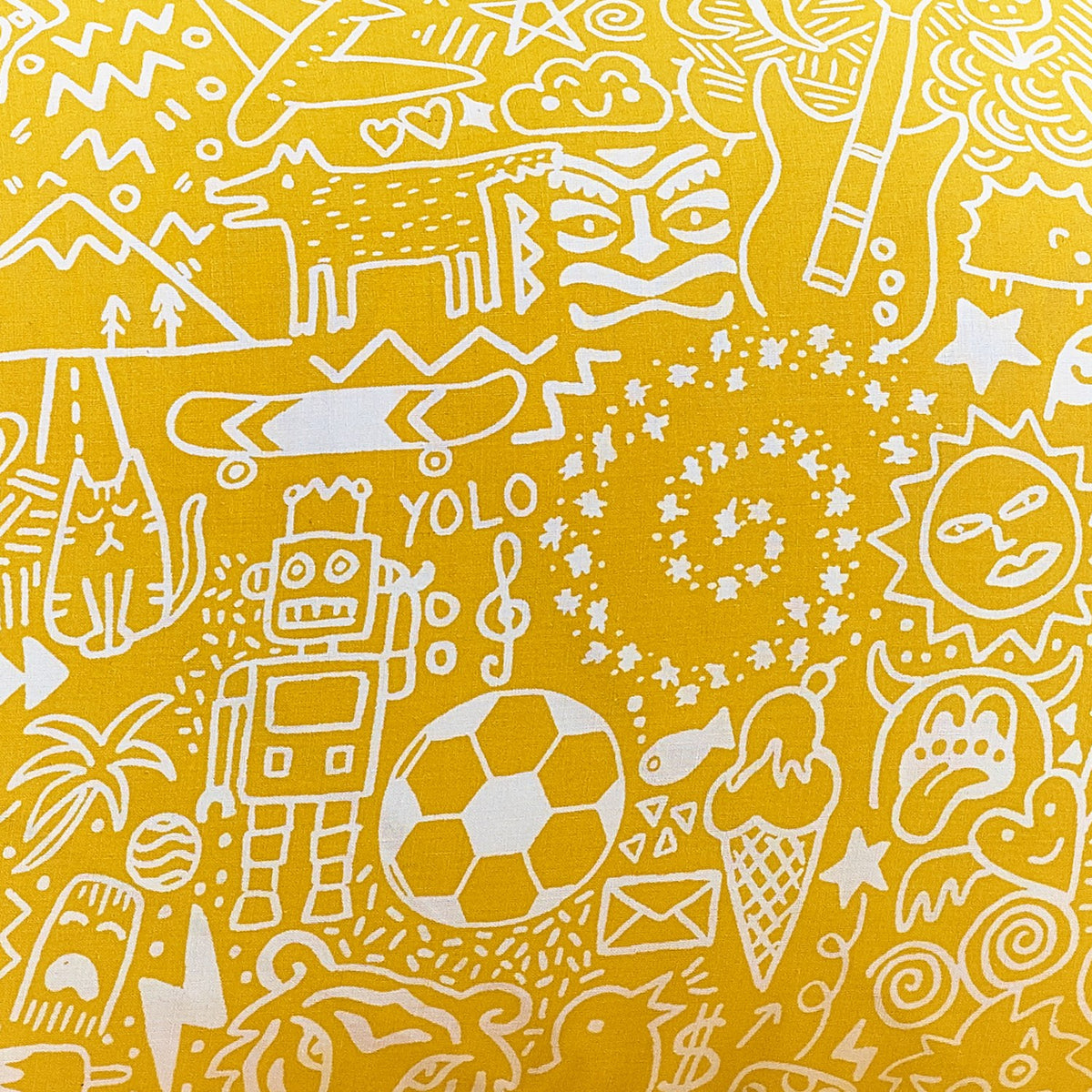 Close-up of the yellow reverse side of the Doodles Polycotton Duvet Cover Set, showing white line-drawn robots, animals, footballs and stars in a dense doodle pattern.