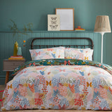 Teal Forage Printed Floral Duvet Cover Set with matching pillowcases, featuring butterflies, flowers and grasses in coral, blue and amber on a teal-green ground.