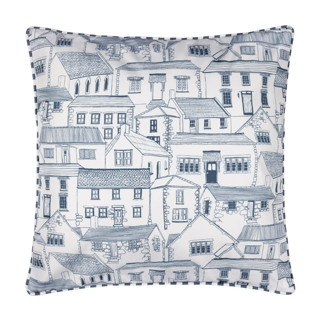 Square Abersoch Town reversible polyester cushion with hand-drawn blue coastal town houses on a white ground and striped piped trim edging, shown on a plain background.