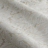 Close-up of Acanthus Jacquard Linen Pencil Pleat Curtains fabric, showing a raised woven scrolling leaf pattern in ivory-cream on a beige ground.