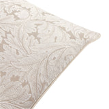Close-up of the Acanthus Jacquard Linen Cushion corner showing a woven cream acanthus leaf pattern with piped edge on a natural linen ground.