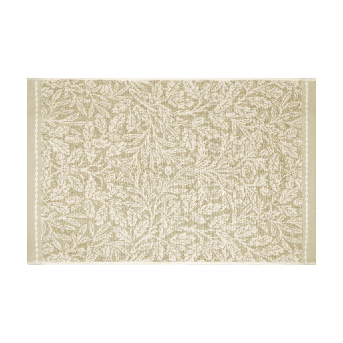Acorn Floral Cotton Bath Mat in natural beige and cream, woven with a trailing Morris acorn and oak leaf pattern with slim side borders, shown on a plain white background.