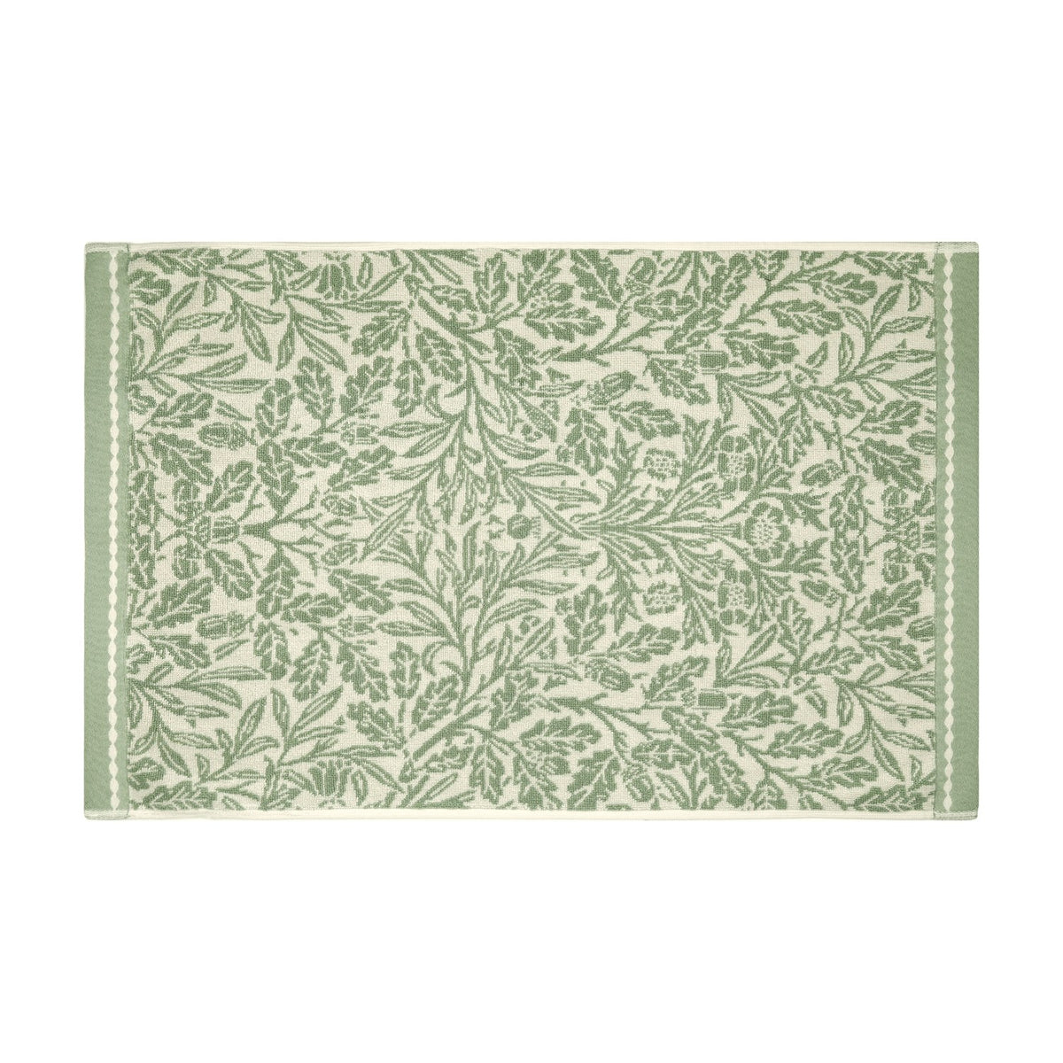 Acorn Floral Cotton Bath Mat in sage green, woven with an oak leaf and acorn design on a cream ground, framed by a plain green border, shown on a white background.