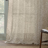 Acorn Damask Linen Curtain Panel in natural cream, semi-sheer voile with printed acorn and foliage design, shown floor-length beside a window in a living room setting.