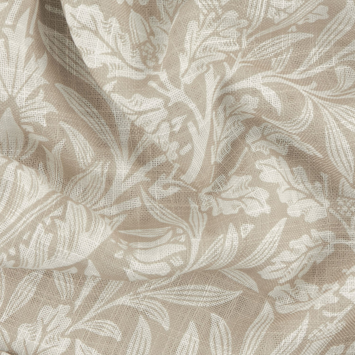 Close-up of the Acorn Damask Linen Curtain Panel, showing a semi-sheer voile fabric with a printed leaf and floral pattern in cream on a natural ground, gathered in soft folds.