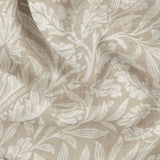 Close-up of the Acorn Damask Linen Curtain Panel, showing a semi-sheer voile fabric with a printed leaf and floral pattern in cream on a natural ground, gathered in soft folds.